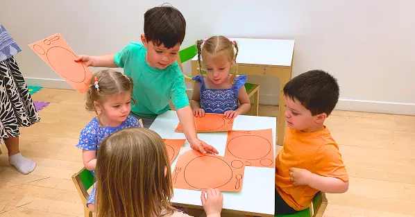 Children coloring at a craft table