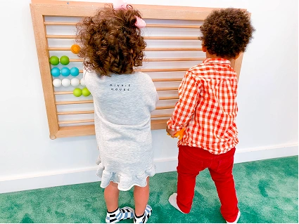 Children playing with an abacus wall